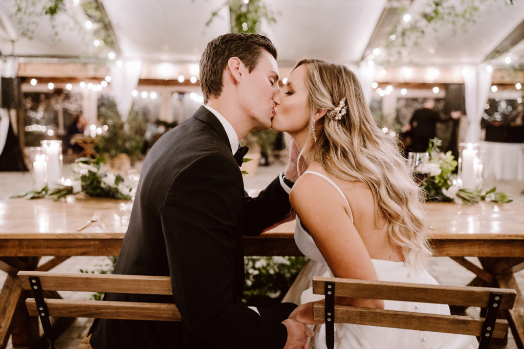 bride and groom steal a kiss during their reception at their long hollow gardens wedding