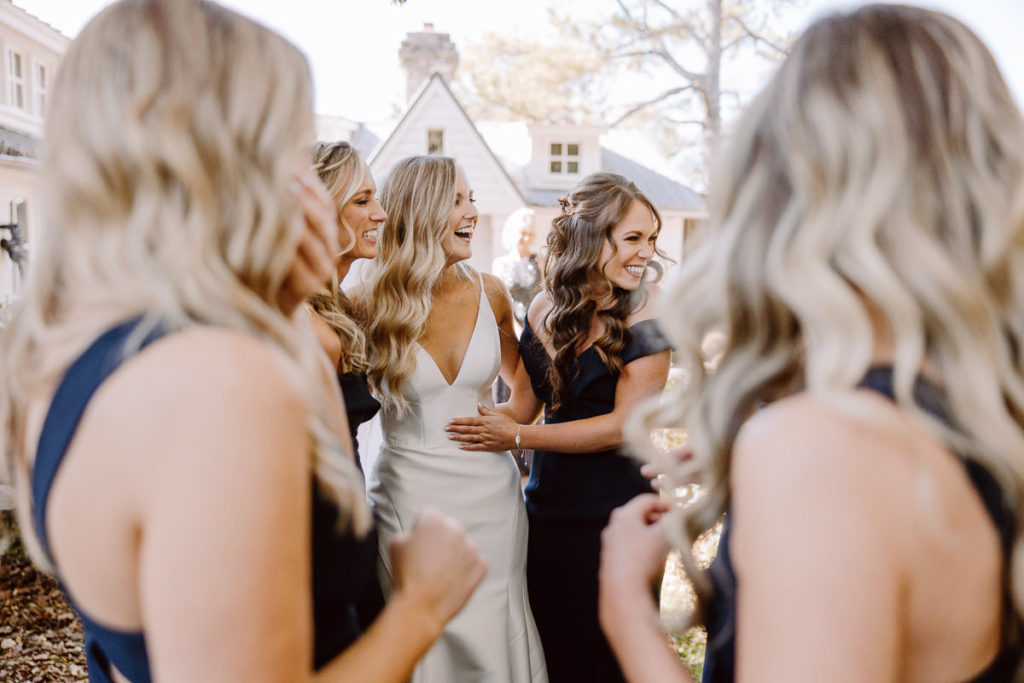 bride laughs with bridesmaids at long hollow gardens nashville wedding venue