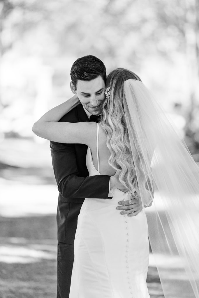 bride and groom embrace after emotional first look at long hollow gardens wedding venue