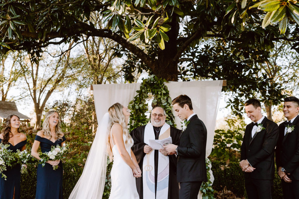 candid moment as groom reads his emotional vows during sunset ceremony at long hollow gardens