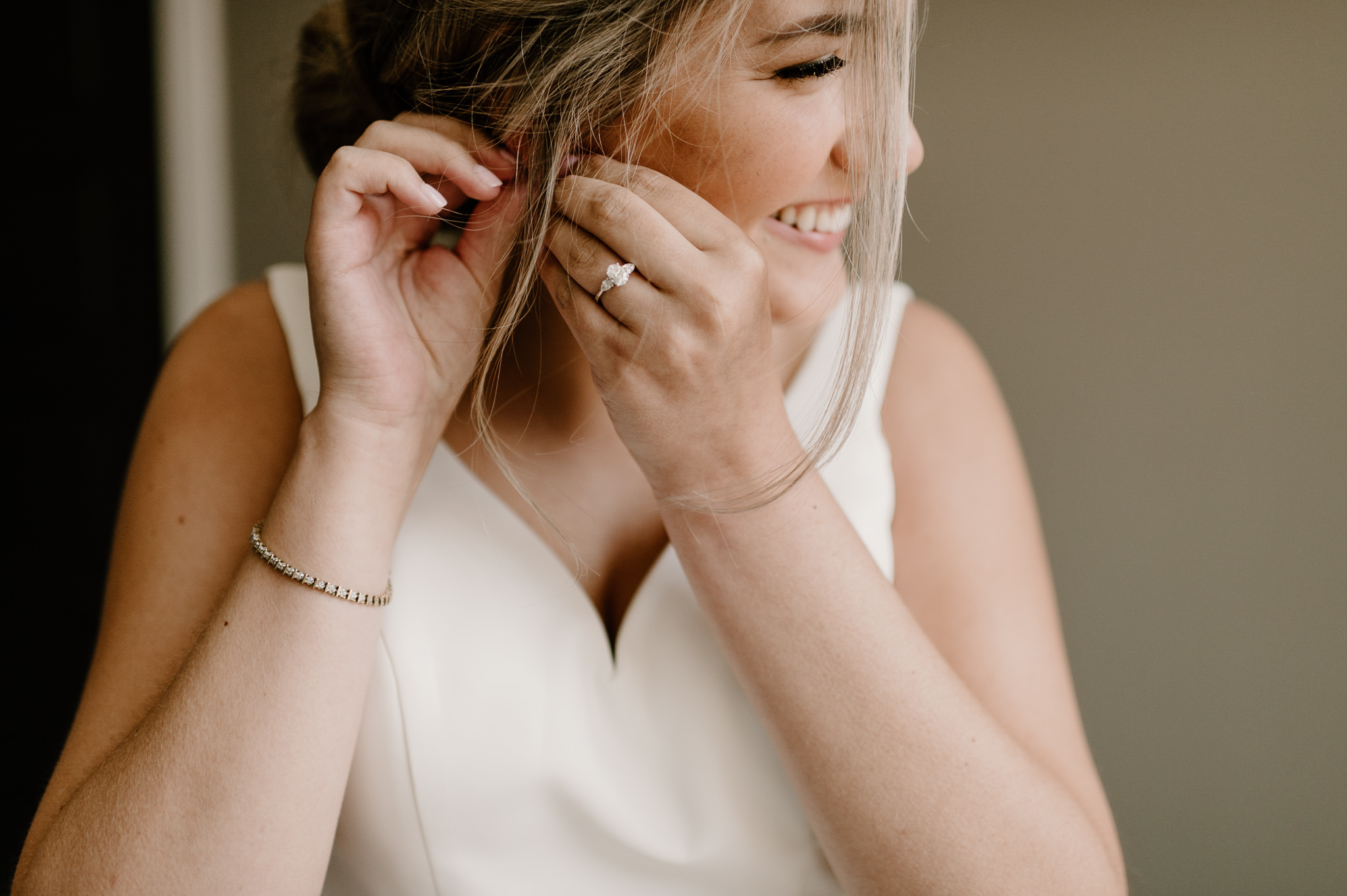 Smiling candid bride getting ready at riverwood mansion